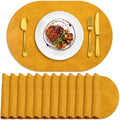 ADRIMER Oval Placemats Set of 12, Wipeable Faux Leather, Yellow