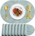 ADRIMER Oval Placemats Set of 8, Wipeable Faux Leather, Light Blue