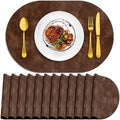 ADRIMER Oval Placemats Set of 12, Wipeable Faux Leather, Brown